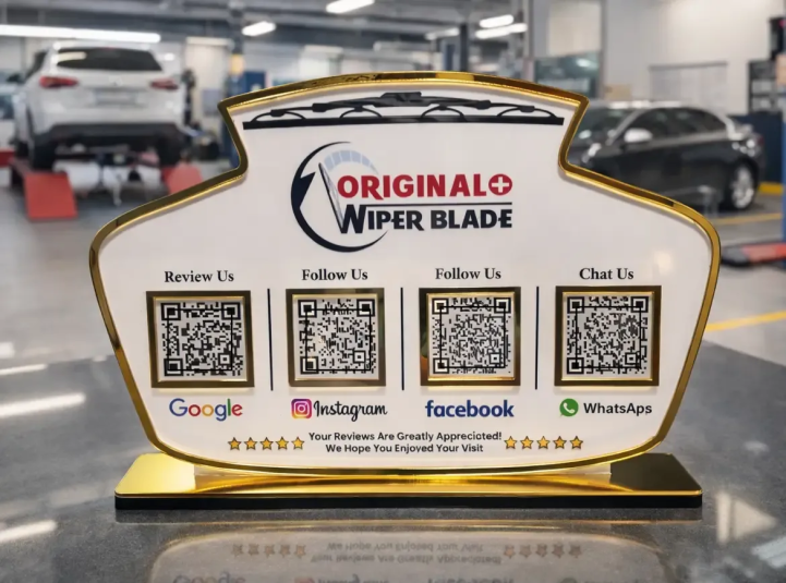 Automotive NFC Standee – 4 QR Code Display Automotive NFC standee with four QR codes and gold base for reviews, social media, and customer chat on a service counter