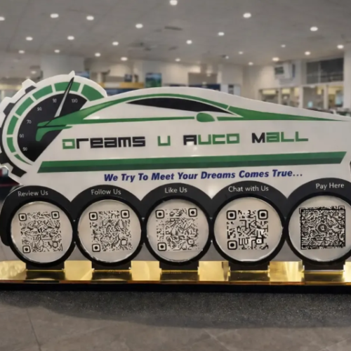 Automotive NFC standee with five QR codes and gold base for reviews, payments, and customer engagement in a car showroom