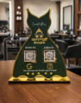 Google review and social media NFC standee in dark green and gold acrylic with sculpted design on a business counter