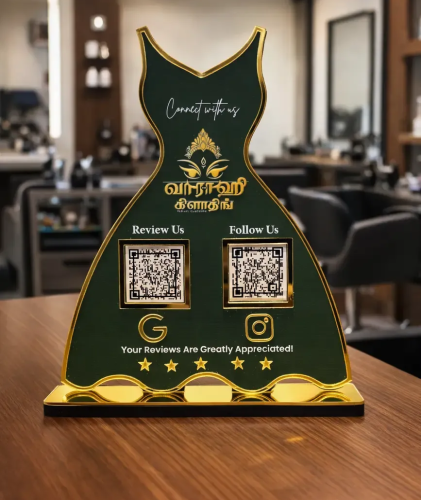 Google review and social media NFC standee in dark green and gold acrylic with sculpted design on a business counter