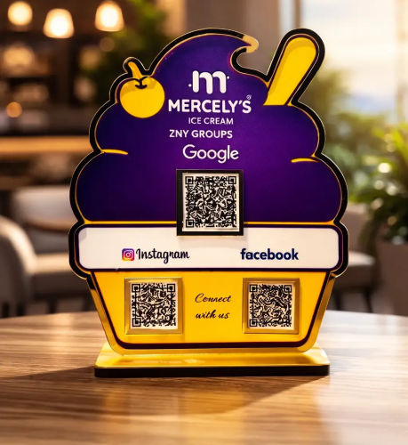 Ice cream–shaped NFC standee with three QR codes for reviews, social media, and payments on a café counter