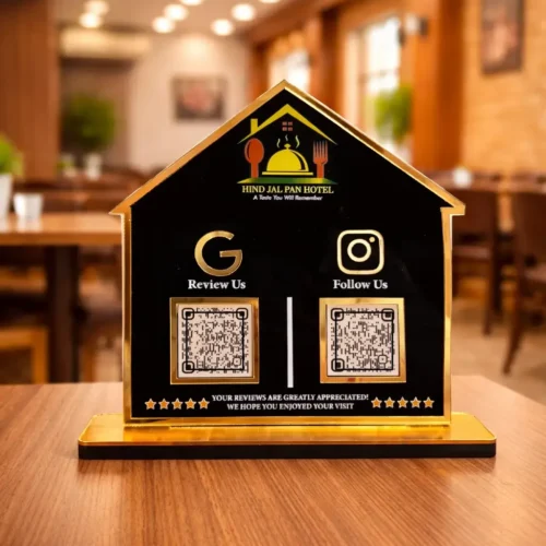 House-shaped restaurant NFC standee with Google review and social media QR codes on a black and gold acrylic display