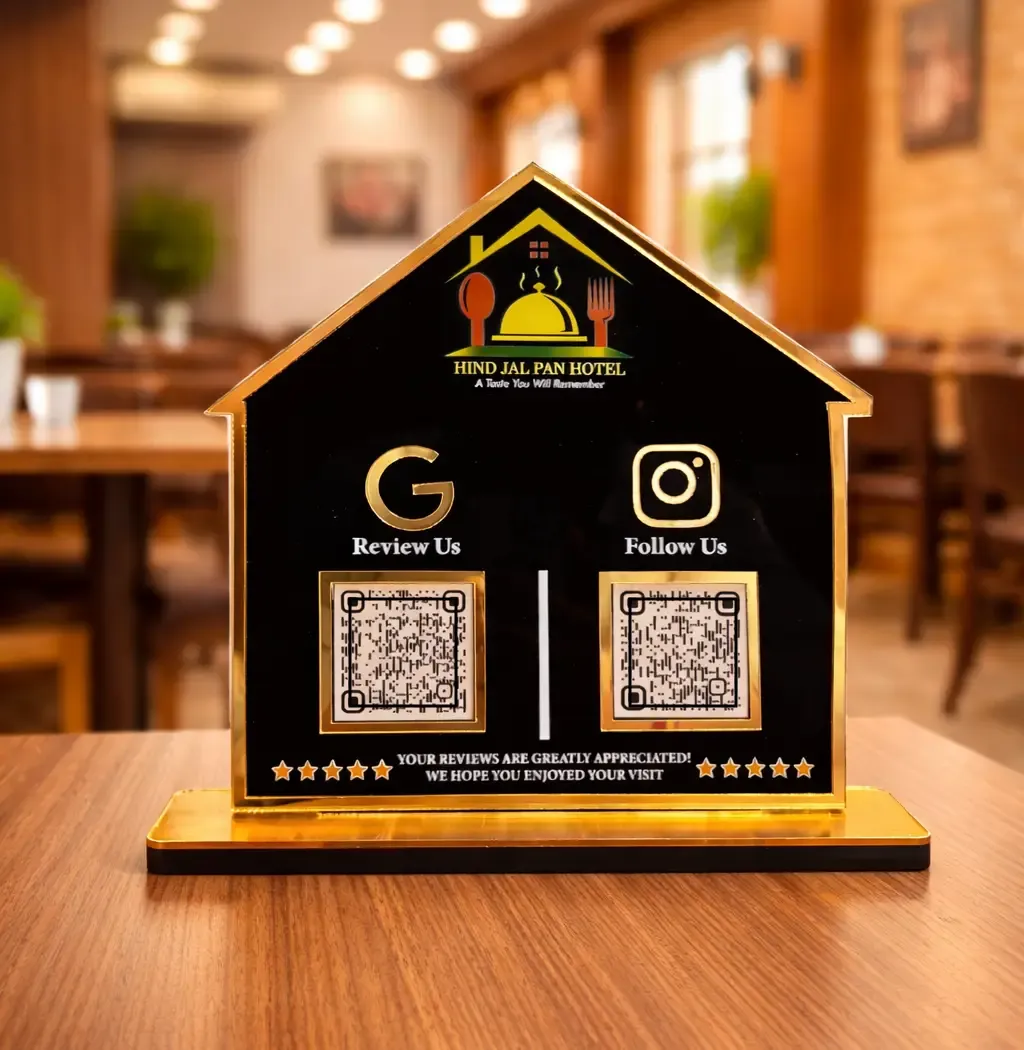 Restaurant NFC Standee – House-Shaped Display House-shaped restaurant NFC standee with Google review and social media QR codes on a black and gold acrylic display